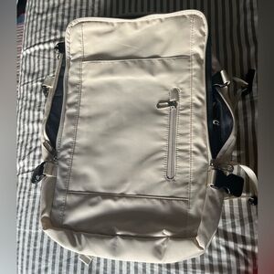 NWOT cream charging travel back pack.